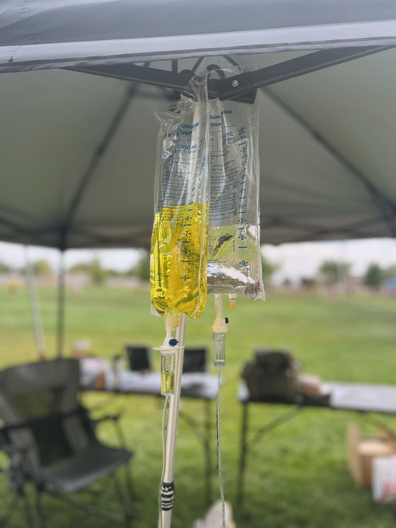 Flowstate IV Therapy booth signage at a community event